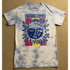 Nwot Spencer's Sublime Graphic Tee Features/Description: Spencer’s White And Blue Tie Dye Graphic T-Shirt. Front Of The Shirt Has The Classic Sublime Sun Logo. Condition: New, Without Tags. No Damages Or Stains. Has Never Been Washed, Used, Or Worn. Measurements: Garment Size Labeled Small. Measurements Are Taken Laying Flat And Are Approximations: Chest: 17.5" Length: 27.5" Color Of The Garment May Appear Different Due To Lighting And Screen Differences. Sublime Sun, Sun Logo, Blue Tie, Blue Tie Dye, Graphic Tee, Graphic T Shirt, Tie Dye, Graphic Tees, Dye