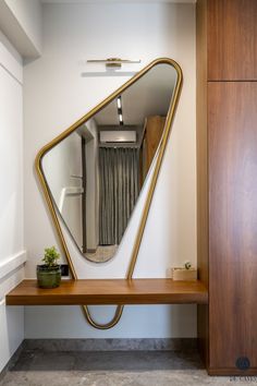 a mirror on a wooden shelf in front of a door