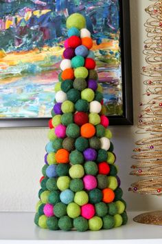 a christmas tree made out of pom - poms on top of a table