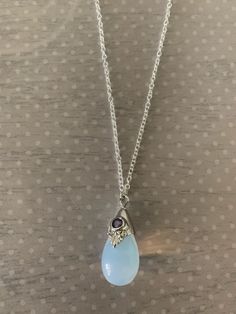 "Lovely moonstone white teardrop shaped necklace featuring silver tone regal motif with purple inlaid gem stone. Pendant measures 7/8\" L X 1/2\" W and is on an 18\" chain. Note: This is a slightly smaller version of this necklace sold prior to 6/30/20. Also available with a black stone under the following listing: https://www.etsy.com/listing/858843851/moonstone-necklace-moon-stone-necklace?ref=listings_manager_grid ★ Want to see more? Please visit my shop at: https://www.etsy.com/shop/DesignsB Purple Gemstone Necklace, Moonstone Necklace Pendants, Moonstone Aesthetic, Moon Stone Jewelry, Moon Stone Necklace, Gem Stone Pendant, Gem Stone Necklace, Purple Stone Necklace, Purple Pendant