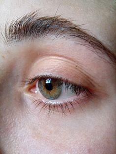 a close up of a person's eye with brown eyes