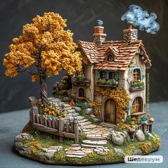 a figurine of a house with trees and flowers