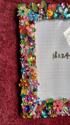 a photo frame is covered with colorful beads and other things to make it look like they have been made out of paper