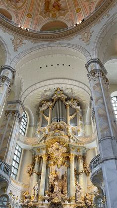 the inside of a church with an ornate organ