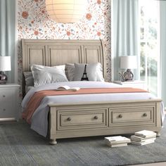 a bedroom with a bed, dressers and two lamps on the side of it