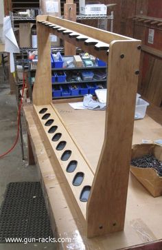 a large wooden shelf with holes in the middle and several other items on top of it