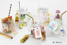 several jars filled with different types of condiments and spices on a white surface