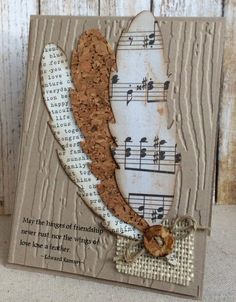 a card with music notes and a feather