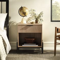 a bed room with a neatly made bed and a night stand