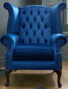 a blue chair sitting on top of a hard wood floor