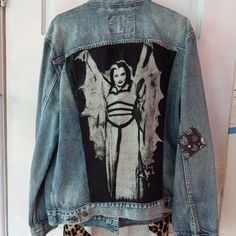 a jean jacket with an image of a woman on it