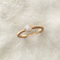 "This beautifully simple wire wrapped ring is lovingly handmade with a Rainbow Moonstone and a choice of 14k Gold Filled, 14k Rose Gold Filled or Sterling Silver band. M A T E R I A L S: * Rainbow Moonstone * 14k Gold Filled, 14k Rose Gold Filled or Sterling Silver S I Z E: *  Gemstone - Approximately 4mm All of our jewellery is carefully handmade using good quality materials and handpicked gemstones, with the aim to produce quality pieces that you can love & wear for years to come.  M O O N S T O N E: * June Birthstone * Talisman for Cancer, Libra & Scorpio * Third Eye Chakra, Solar Plexus Chakra A stone for \"new beginnings\", Moonstone is a stone of inner growth and strength.  It soothes emotional instability and stress, and stabilises the emotions, providing calmness.  Moonstone enhanc Adjustable Wire Wrapped Rose Gold Ring, Adjustable Rose Gold Wire Wrapped Ring, Minimalist Wire Wrapped Yellow Gold Ring, Minimalist 14k Gold Wire Wrapped Rings, Handmade Adjustable 14k Gold Crystal Ring, Wire Wrapped Rose Gold Rings, Dainty Hand Wrapped Adjustable Rings, Minimalist Wire Wrapped Rose Gold Ring, Minimalist Rose Gold Wire Wrapped Ring