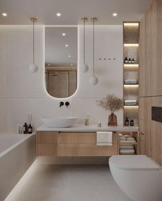 a modern bathroom with an oval mirror above the sink and wooden cabinetry on the wall