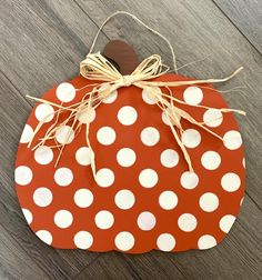 a polka dot pumpkin hanging on a wooden floor