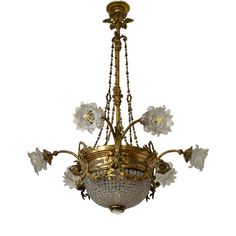 an antique chandelier with glass flowers hanging from it