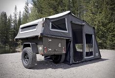 an off - road vehicle with a tent attached to it