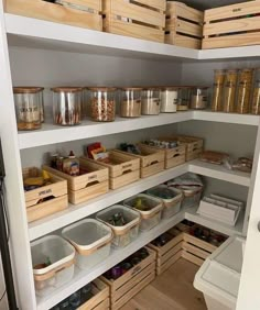 an organized pantry with lots of bins and containers