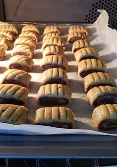 several pastries sitting on top of a baking sheet in an oven, ready to be baked