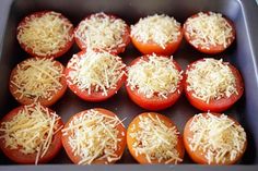 several tomatoes with cheese on them in a baking pan, ready to be cooked and put into the oven