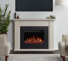 a living room with a television and fire place in the fireplace, along with two chairs