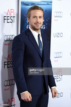 a man in a suit and tie standing on the red carpet at an afi fest event