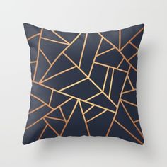 a black pillow with gold lines on it