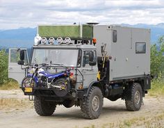 an off - road vehicle parked on the side of a dirt road