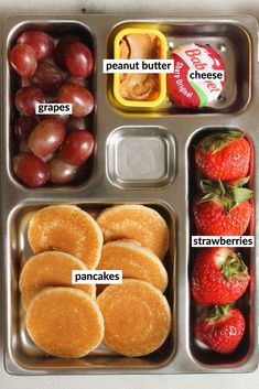 a metal tray filled with different types of food and fruit on top of each other