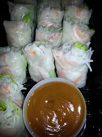 there are many rolls and dipping sauce on the plate with it's wrapper