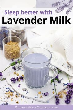 lavender milk in a glass mug with flowers around it and the words sleep better with lavender milk