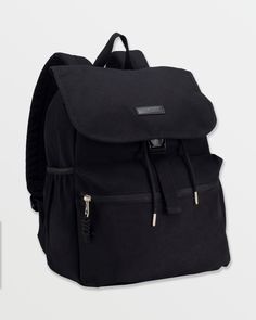 a black backpack sitting on top of a white wall