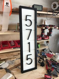 there is a large sign that has the number fifteen five on it and many tools around it