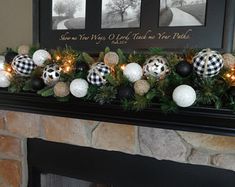 a fireplace mantel decorated with christmas ornaments and plaid baubes, pine cones and greenery