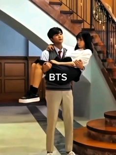 a man holding a woman in his arms on the set of tv show bts