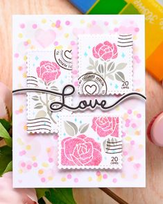 a close up of a card with flowers on it and the word love written in cursive writing