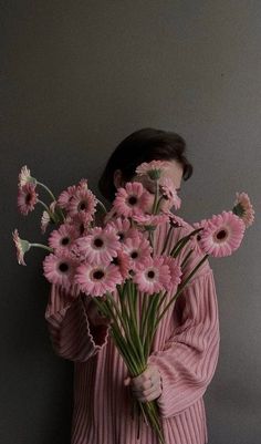 a woman holding flowers in her hands