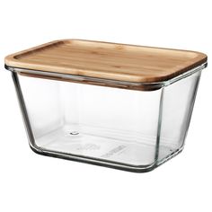 a glass container with a wooden lid on a white background for food storage or cooking