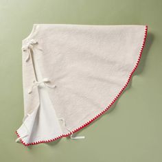 a white towel with red trim is hanging on the wall