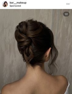 a woman with her hair in a low bun