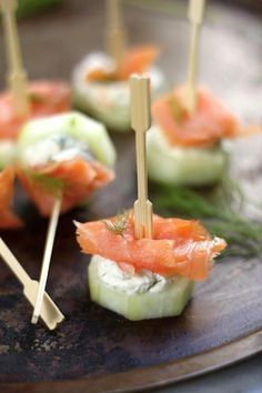 small appetizers with toothpicks and smoked salmon on them are ready to be eaten