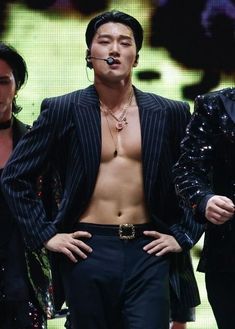 a shirtless male performing on stage at a concert