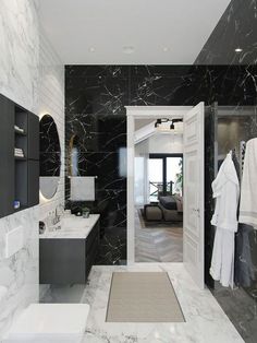 a bathroom with black and white marble walls