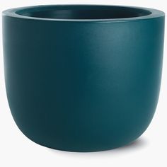 a large green bowl sitting on top of a white table