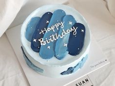 a birthday cake with blue frosting and stars on it