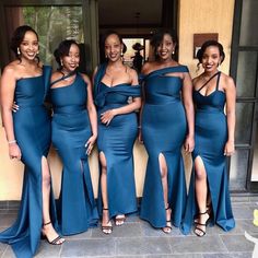 the bridesmaids are posing in their blue dresses and one is wearing black heels