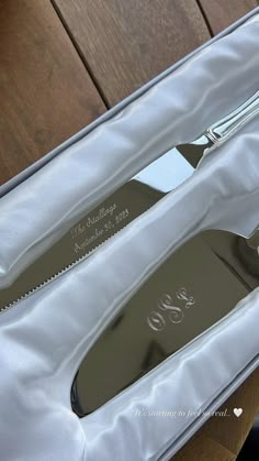 a knife and fork in a silver case on a wooden table with the lid open