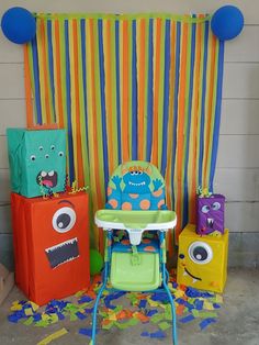 a baby's high chair with monster decorations on the back and sides, next to other toys