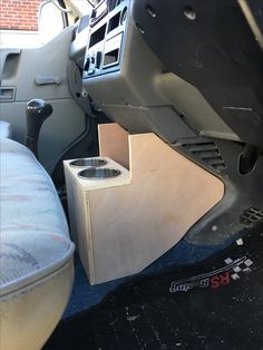 the inside of a vehicle with its door open and some drawers in place on the floor