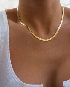 Herringbone chain necklace for a gorgeous slinky layered look Necklace is 14.5" long with 3" extender chain (17.5" total length) Chain is 0.15" (4mm) wide Made from Brass Plated 18K Gold Lobster claw clasp Necklace is 100% nickel-free and cadmium-free Basic Chain Necklace, Gold Necklace Herringbone, Tan Skin Gold Jewelry, Trending Chains For Women, Large Gold Necklace, Gold Classy Necklace, Antique Gold Chain Women, Gold Thick Necklace, Gold Flat Necklace