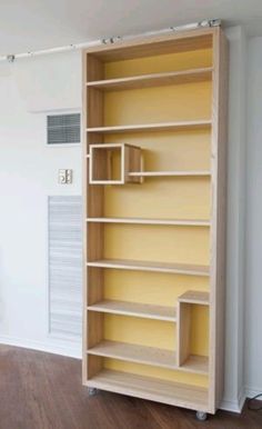 an empty bookcase in the corner of a room